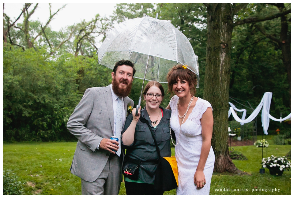 wedding photographer with the bride and groom at backyard wedding in dubuque, ia, candid contrast photography