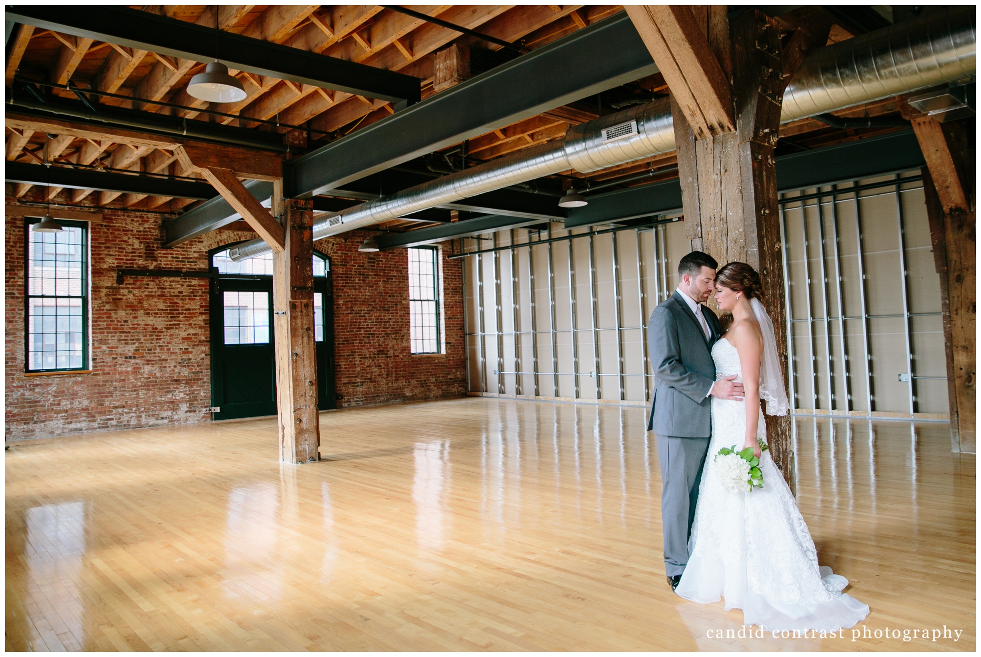 dubuque ia wedding portraits in the millwork district , candid contrast photography 