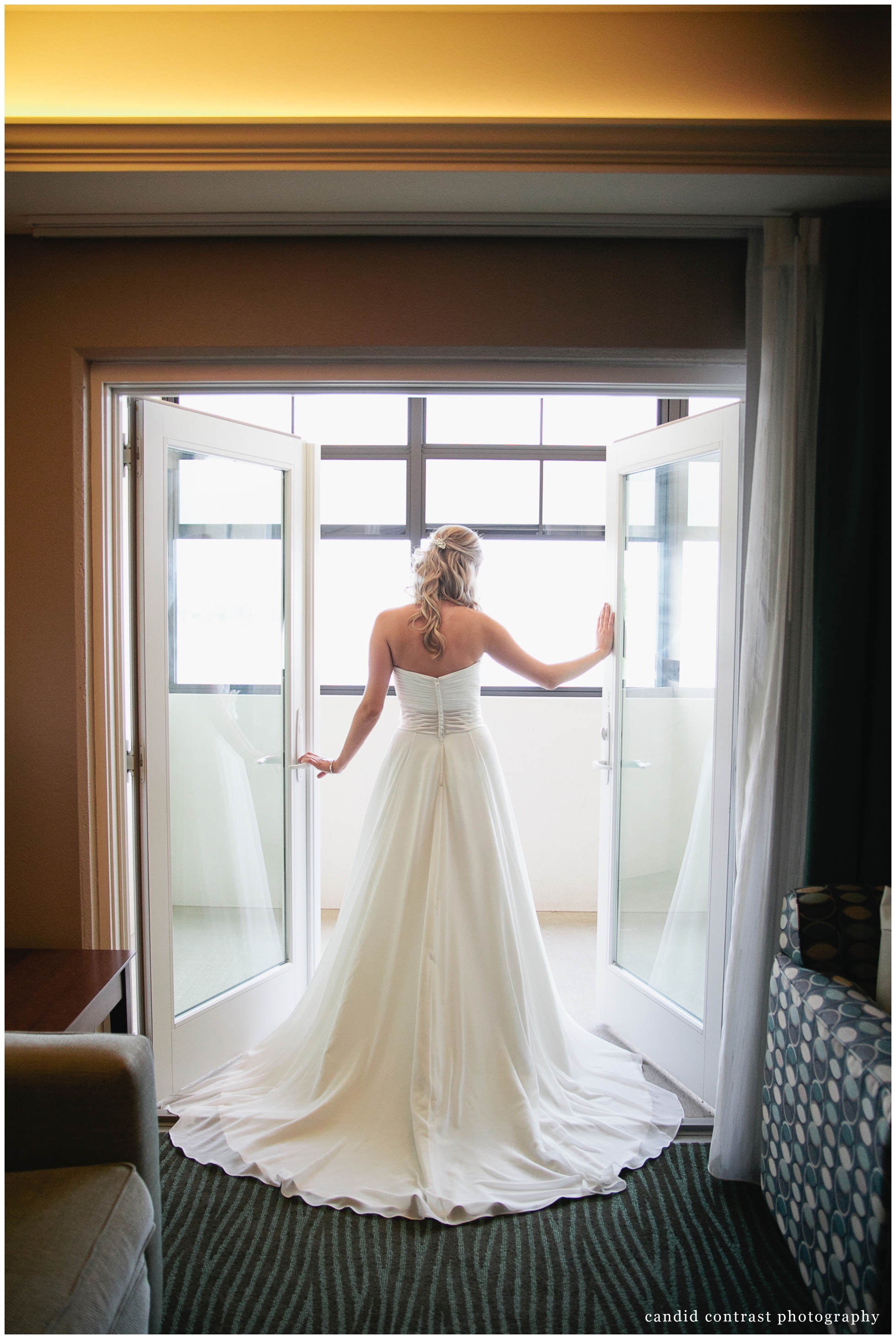 getting ready for Bellevue Iowa wedding at The Shore Event Centre, bride silhouette in doorway, iowa wedding photographer candid contrast photography