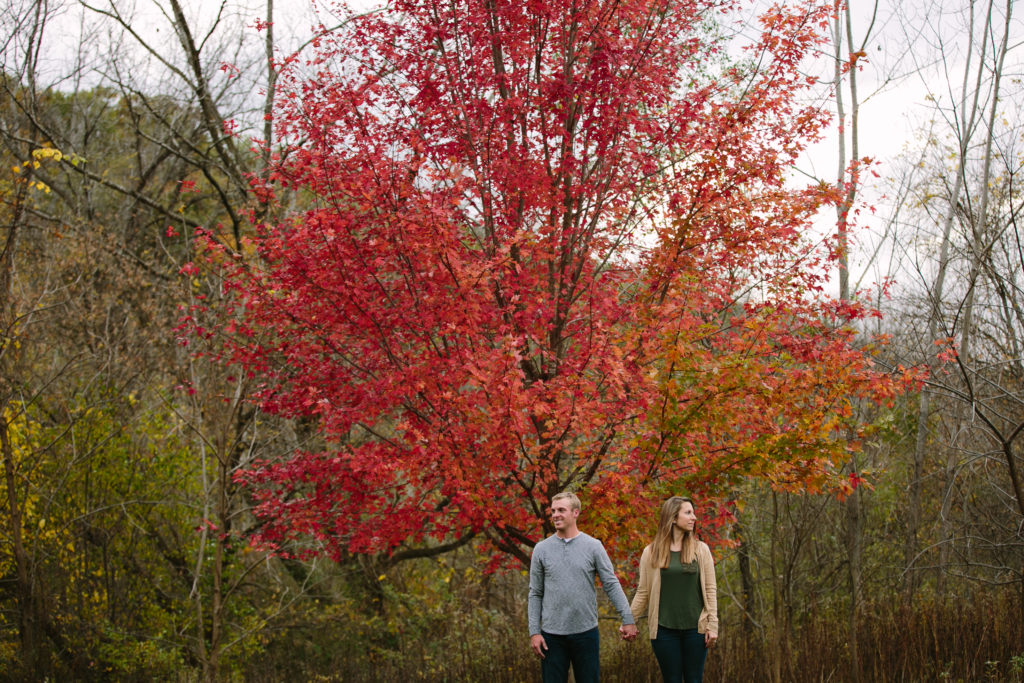 changing leaves during fall engagement photos at mines of spain in dubuque