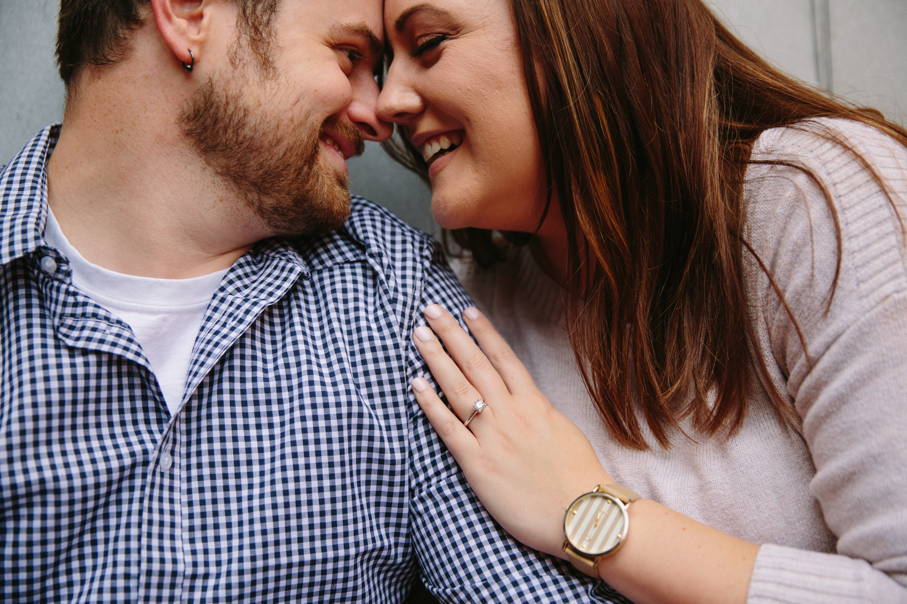 dubuque engagement session by catherine furlin photography, couple snuggling in millwork district