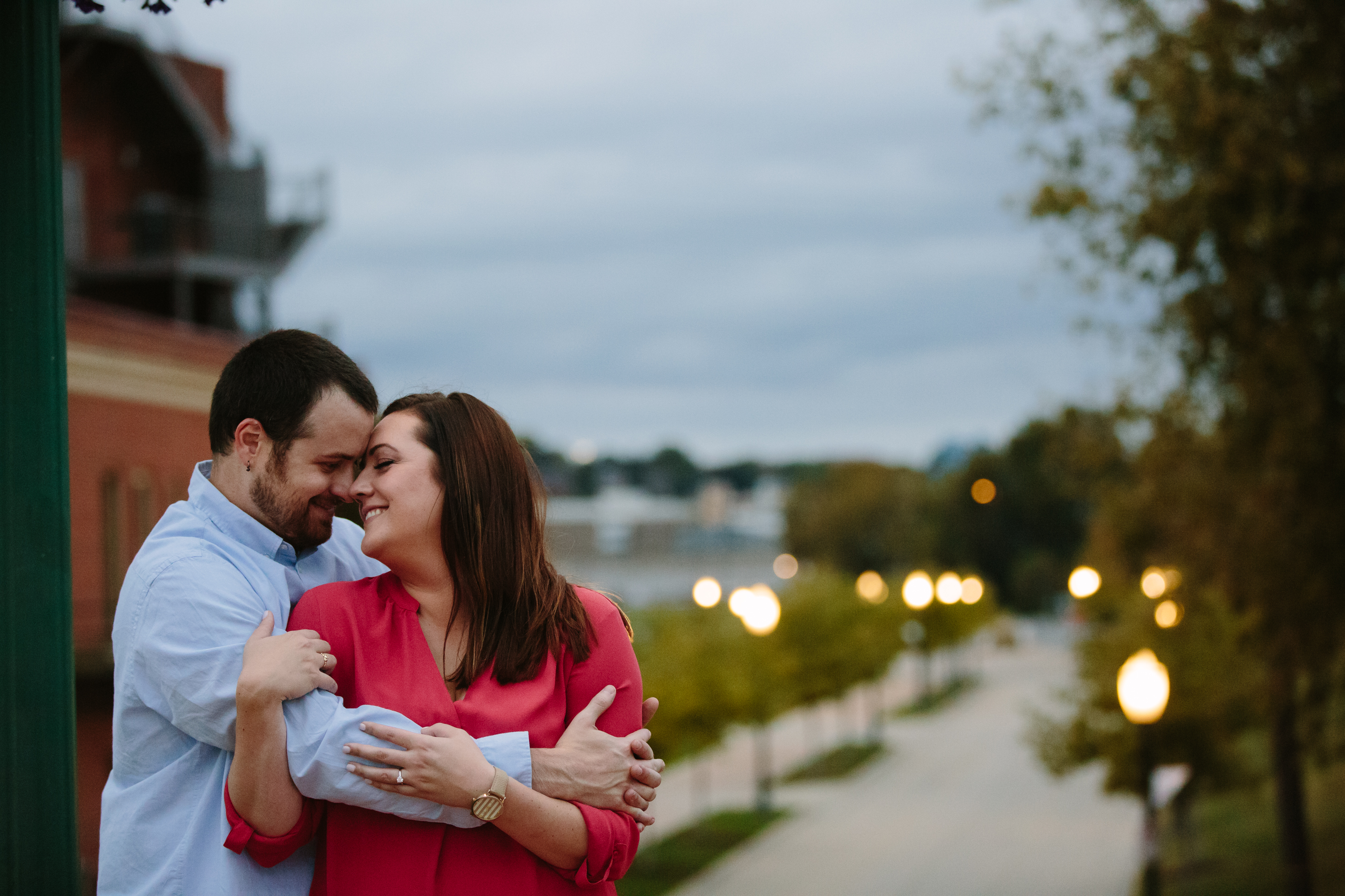 dubuque engagement session by catherine furlin photography, couple snuggling in Port of Dubuque on Mississippi River