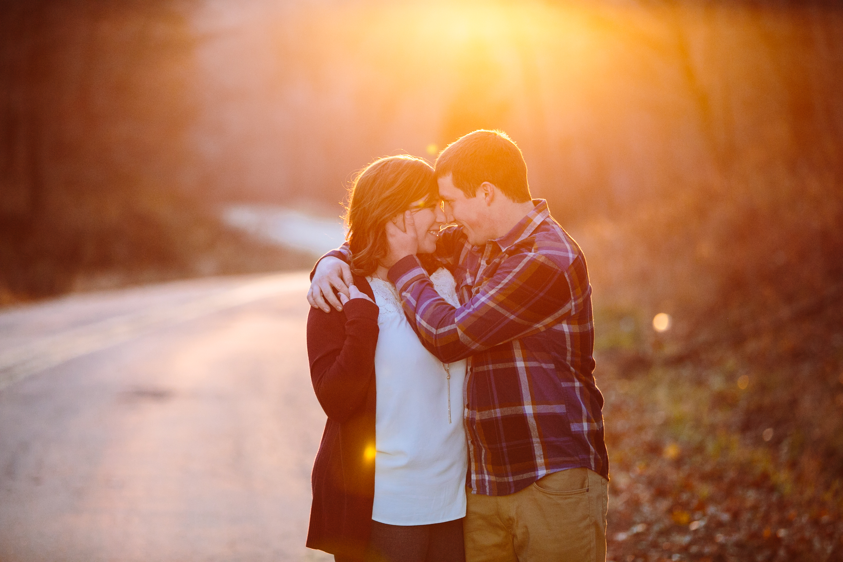 couple in beautiful golden light at sunset, iowa farm engagement session by catherine furlin photography