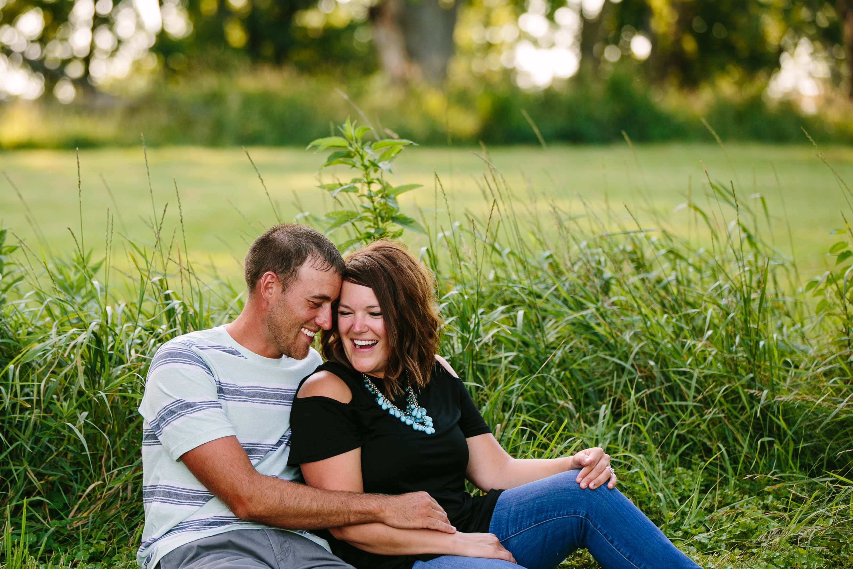 outdoor dubuque engagement session by catherine furlin photography, couple sitting in the grass