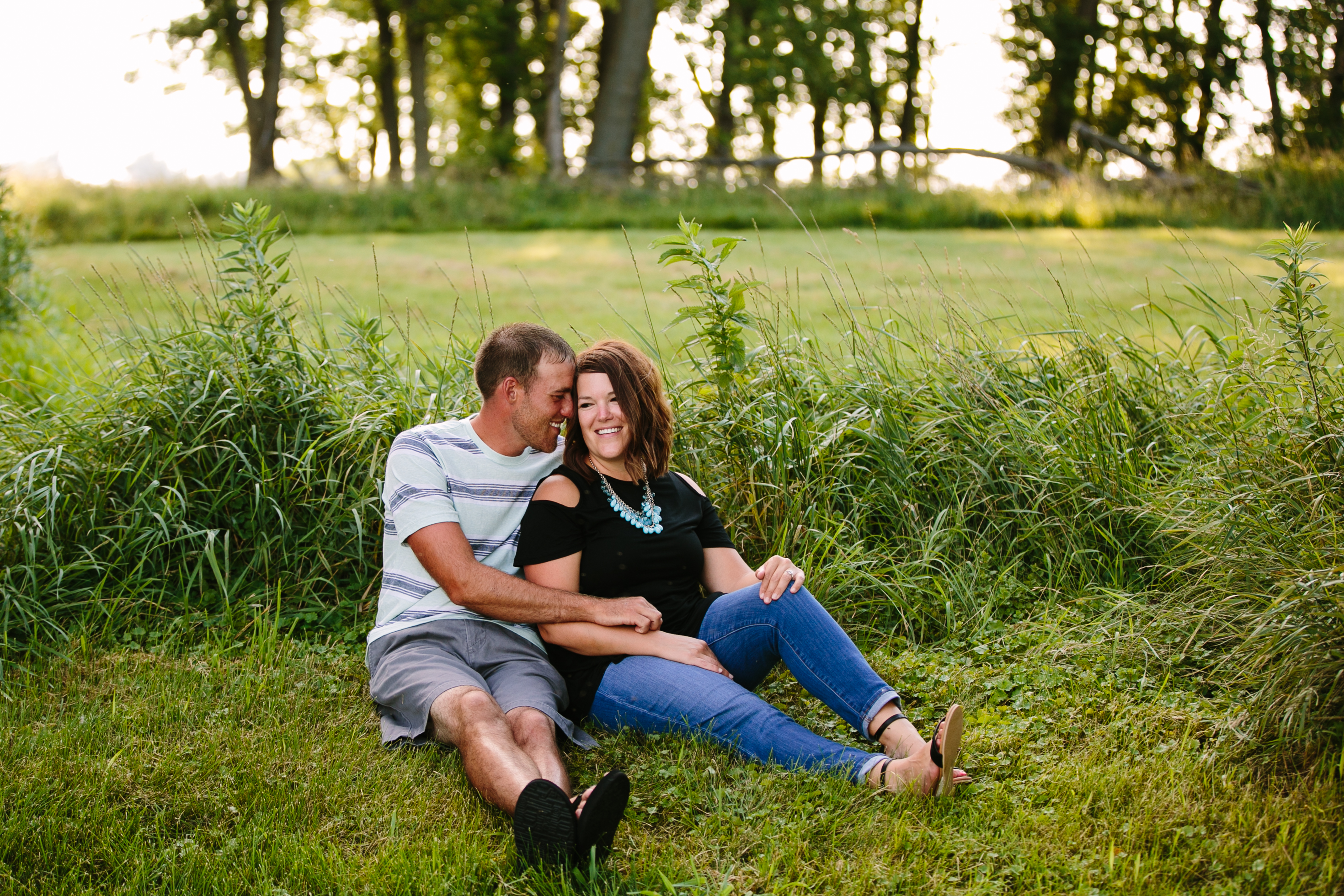 outdoor dubuque engagement session by catherine furlin photography, couple sitting in the grass