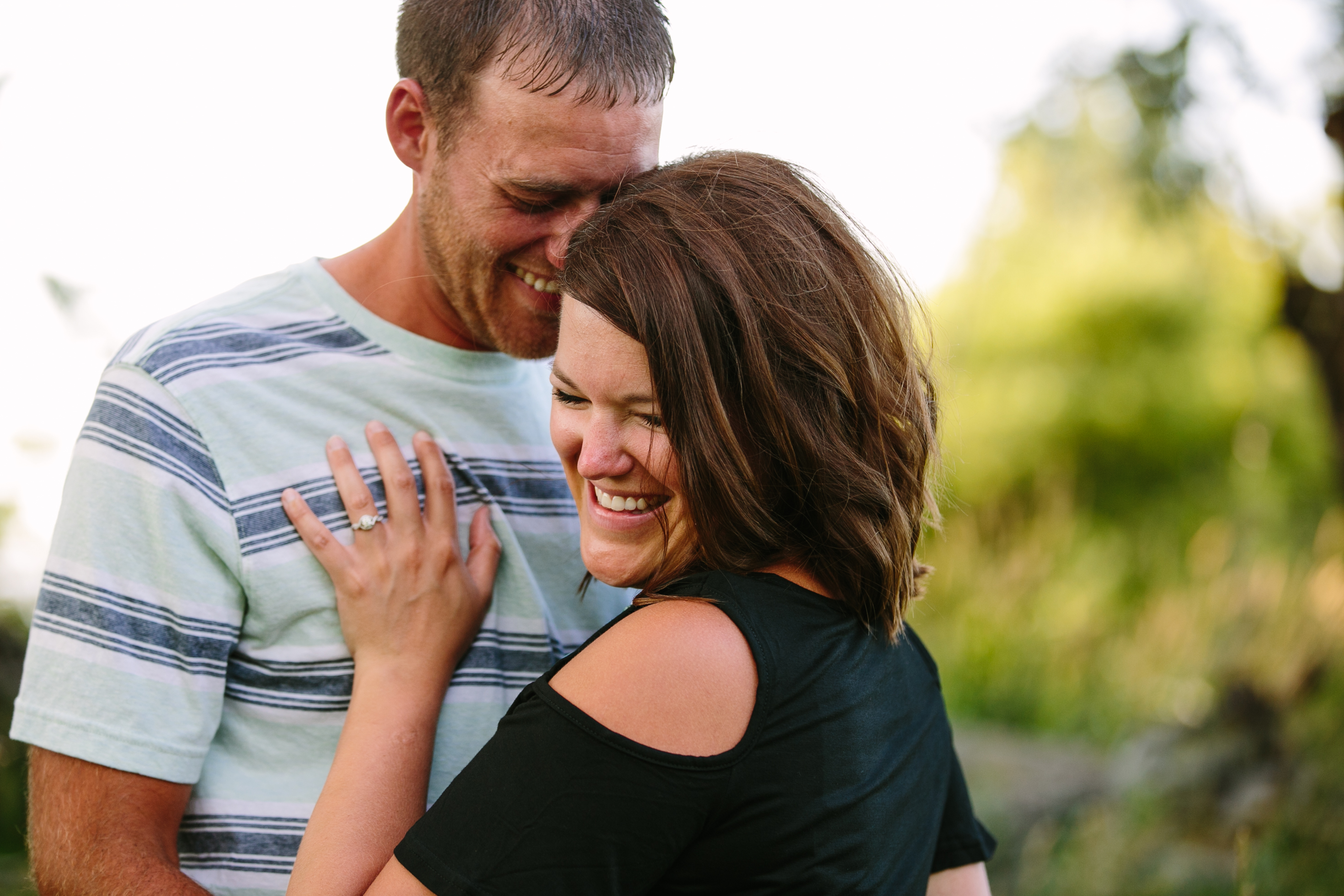 outdoor dubuque engagement session by catherine furlin photography, couple together showing engagement ring
