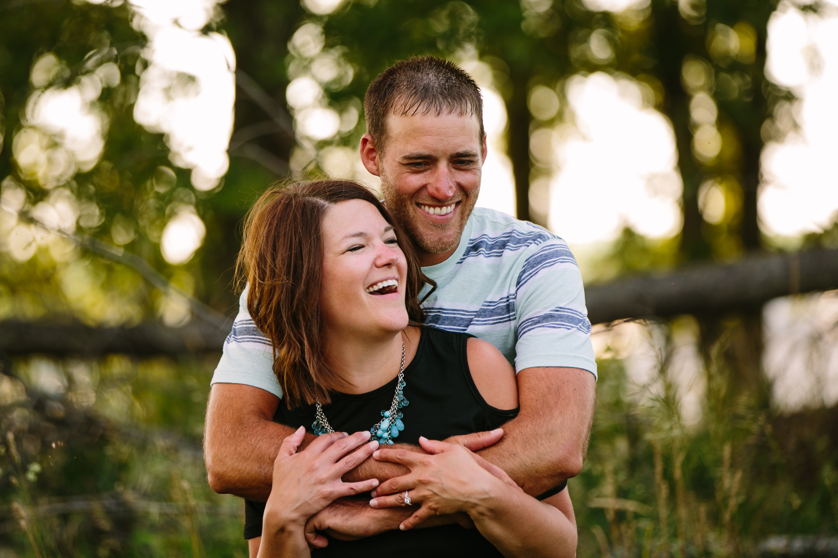 outdoor dubuque engagement session by catherine furlin photography, couple snuggling and laughing