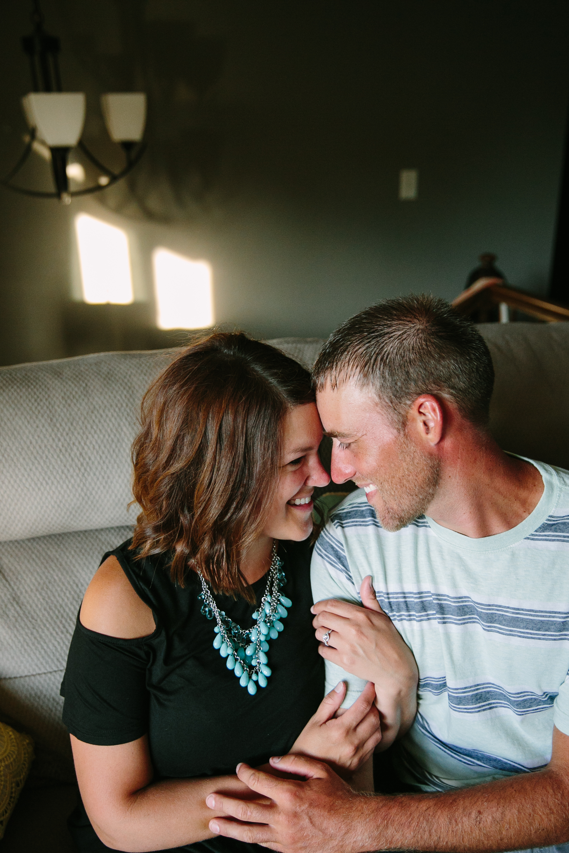 in-home dubuque engagement session by catherine furlin photography, couple snuggling on couch