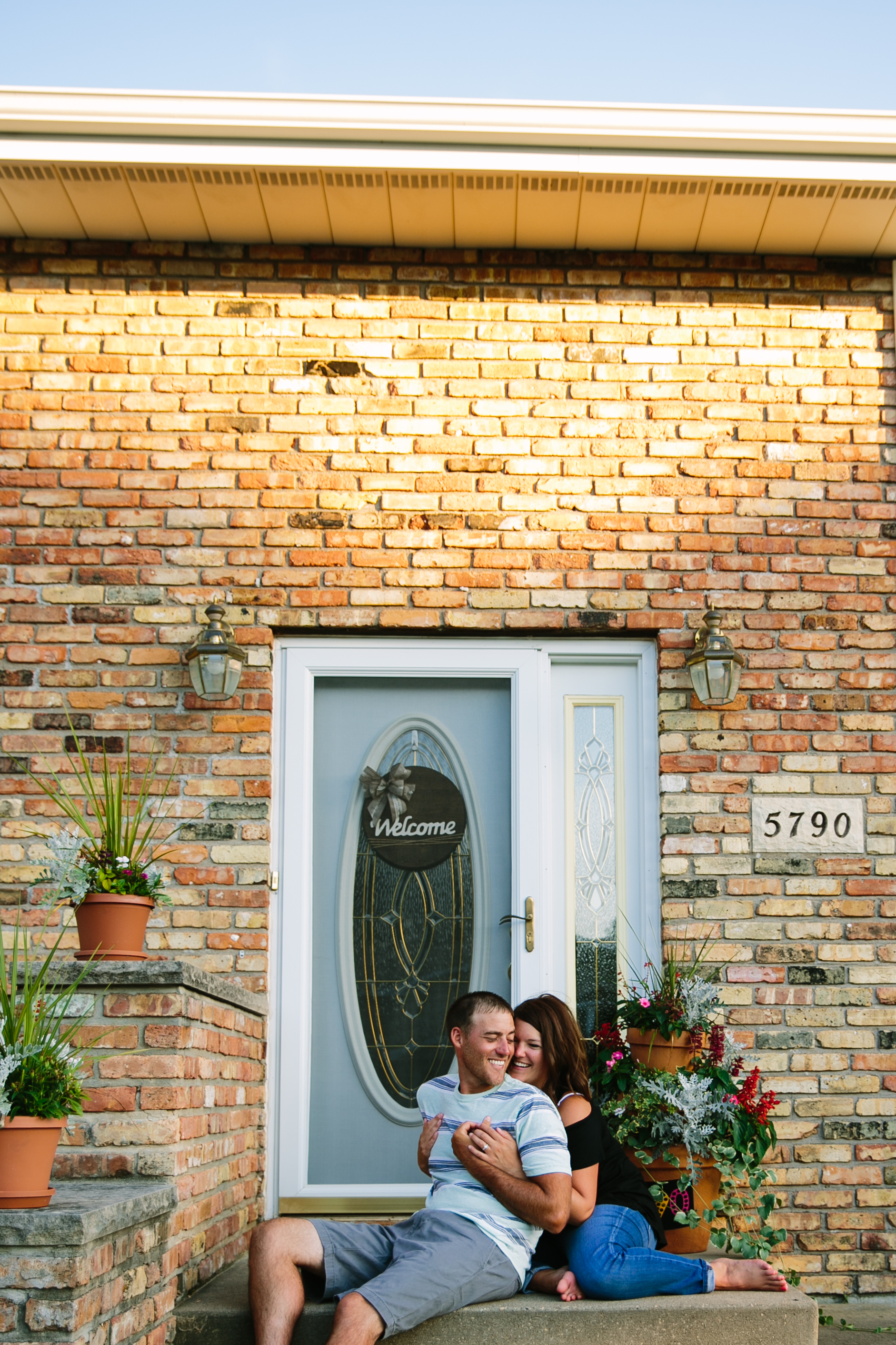 in-home dubuque engagement session by catherine furlin photography, couple sitting on front steps