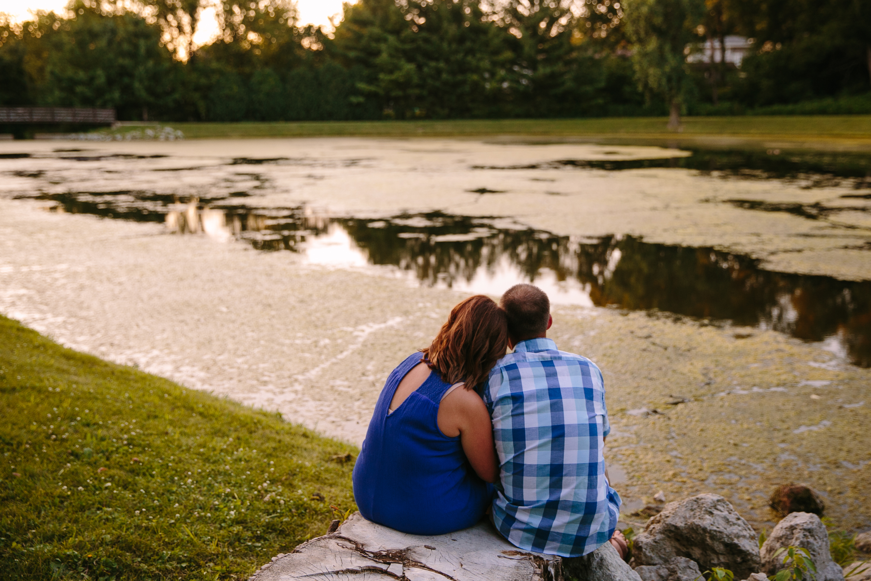 outdoor dubuque engagement session by catherine furlin photography, couple sitting by asbury lake