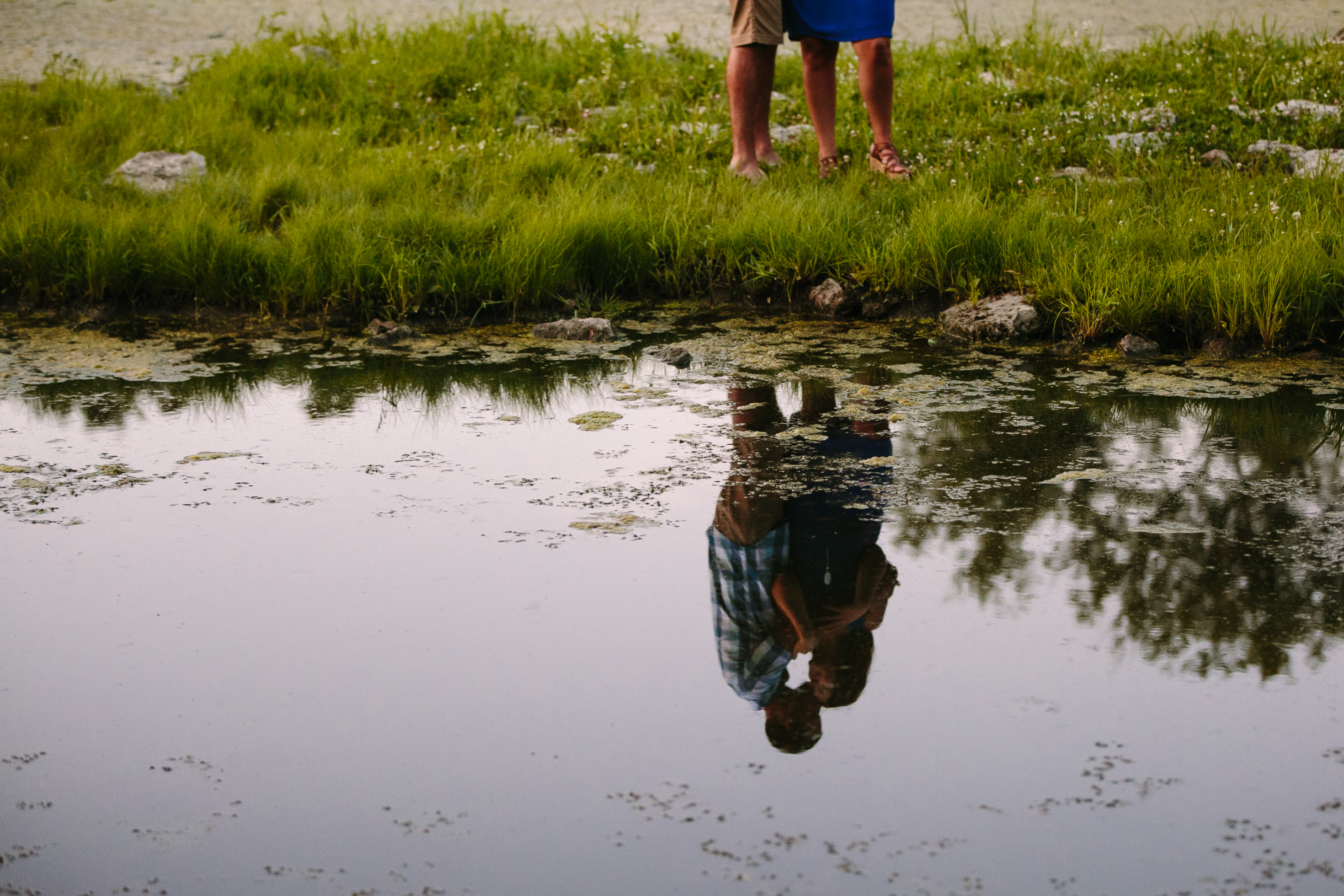 outdoor dubuque engagement session by catherine furlin photography, couple's reflection in asbury lake