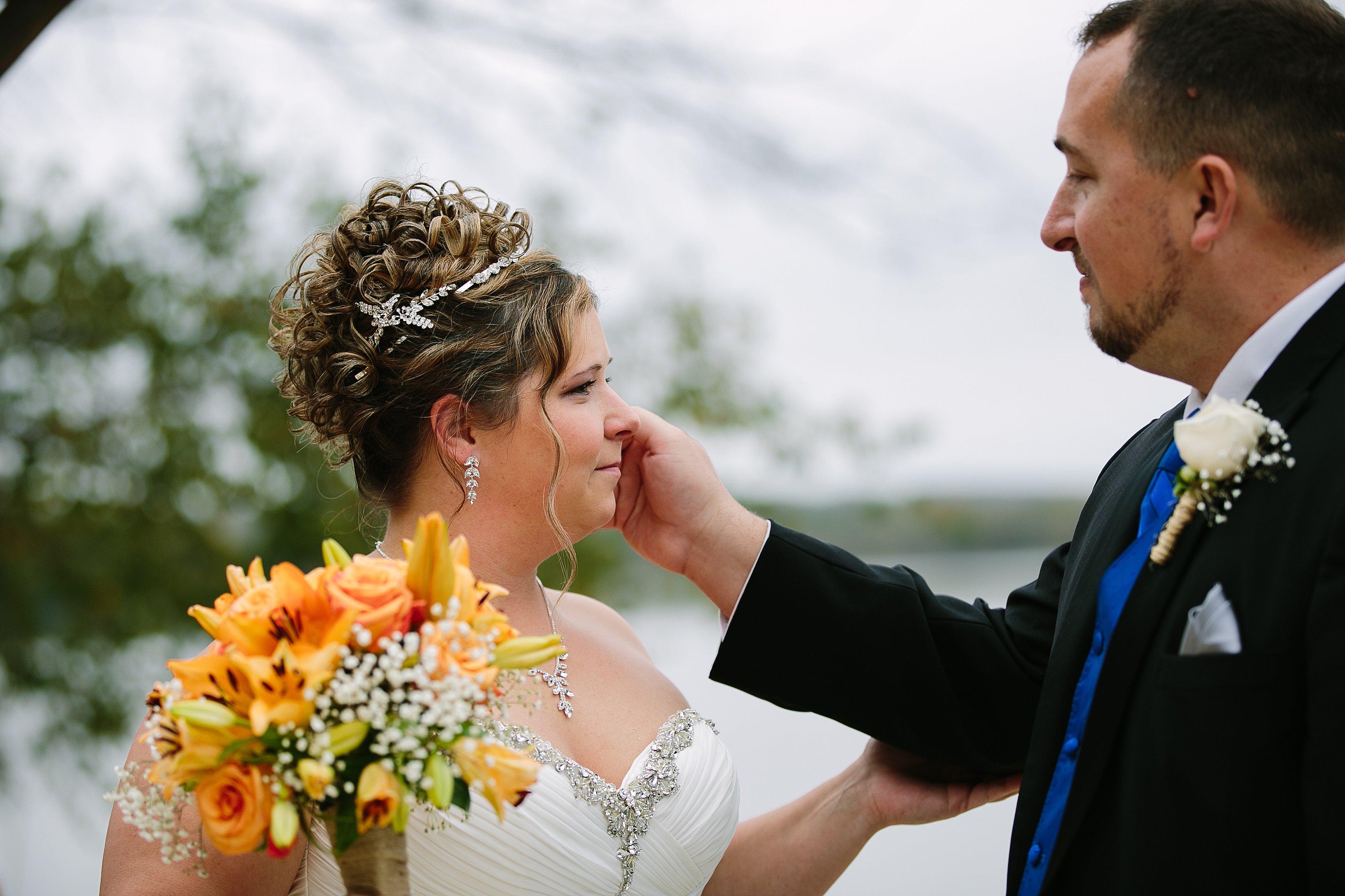 emotional moment between a bride and groom at iowa outdoor wedding wedding, catherine furlin photography