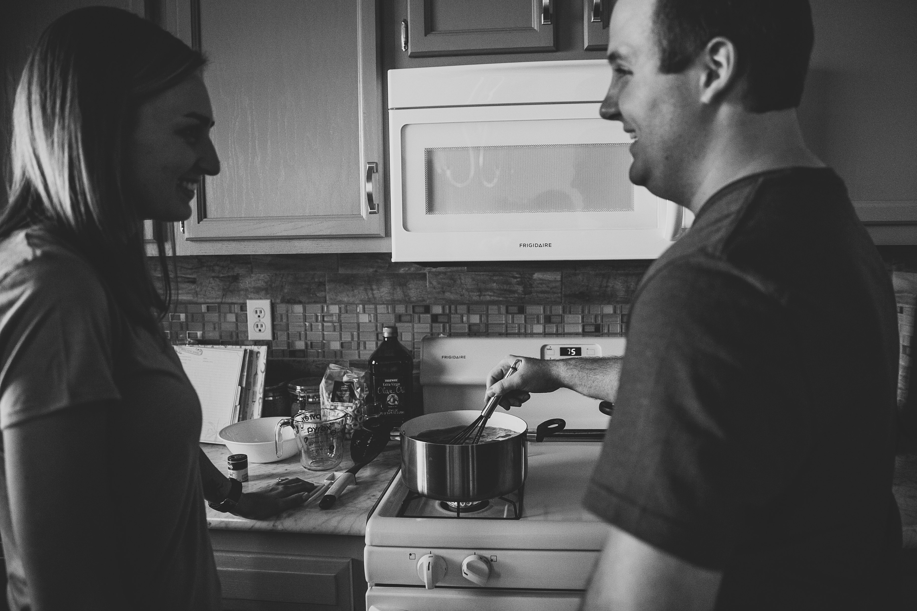 couple cooking dinner together, north liberty wedding photographer