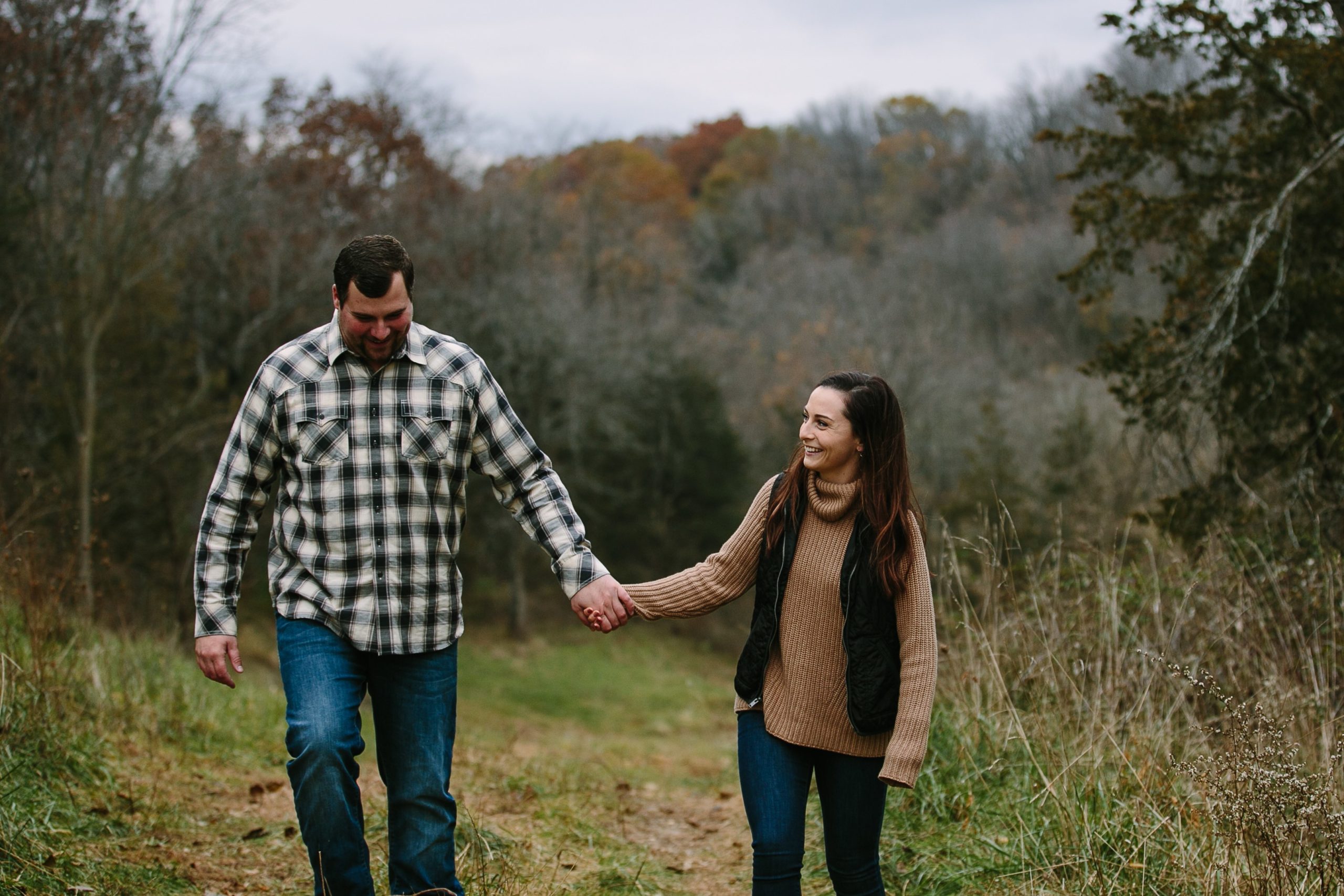 iowa couple holds hands while walking during engagement photos