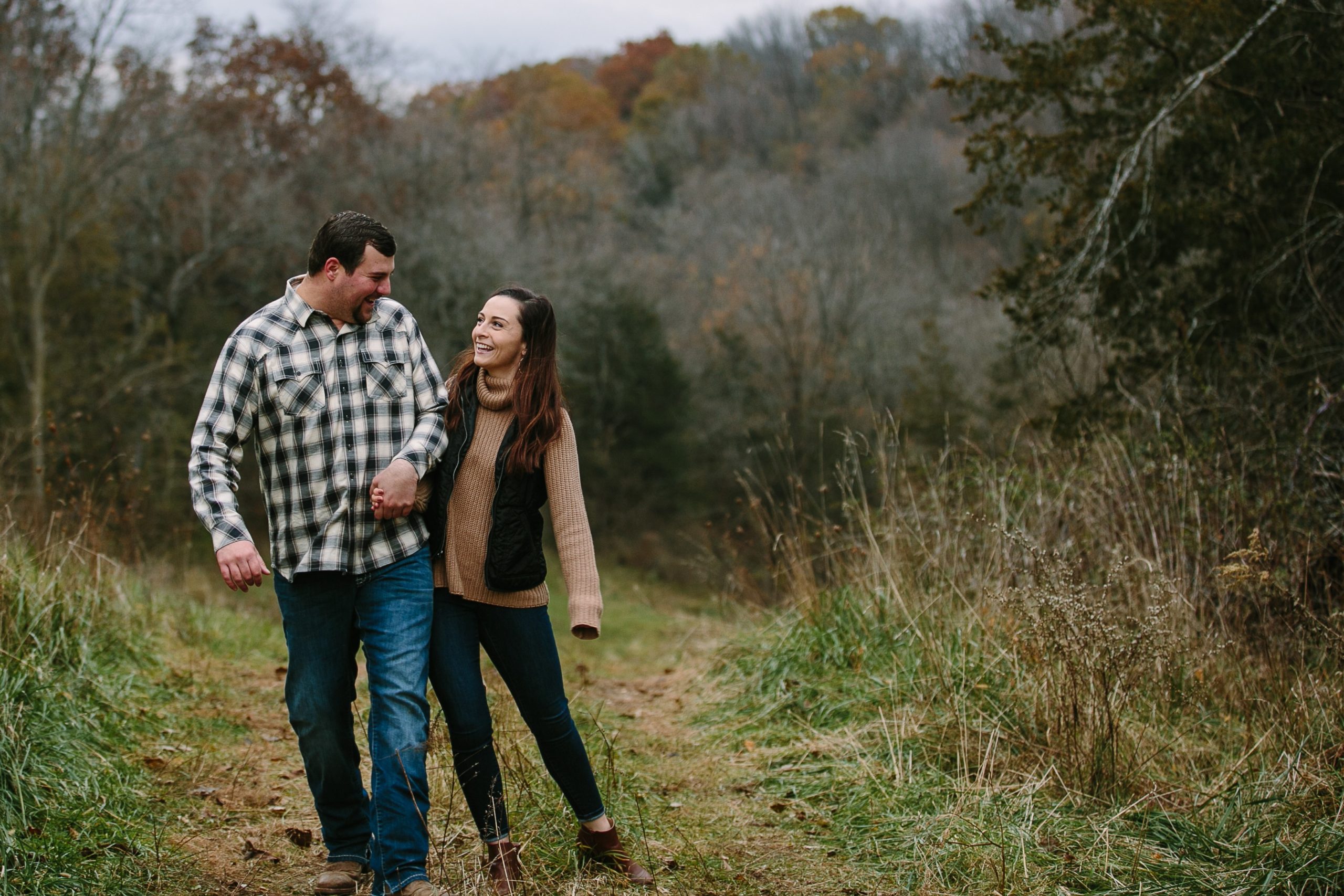 iowa couple holds hands while walking during engagement session
