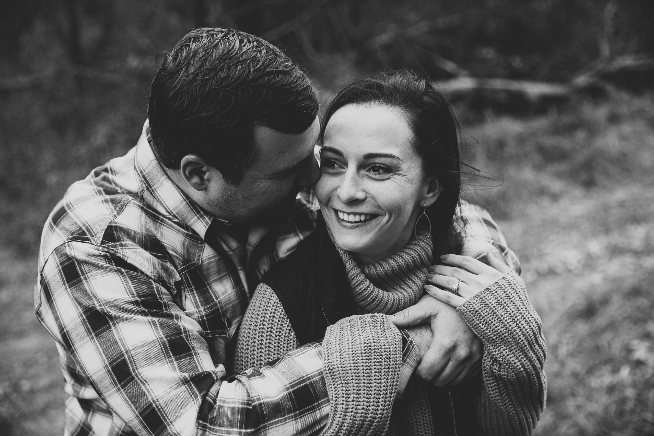 iowa couple wraps arms around each other during engagement session