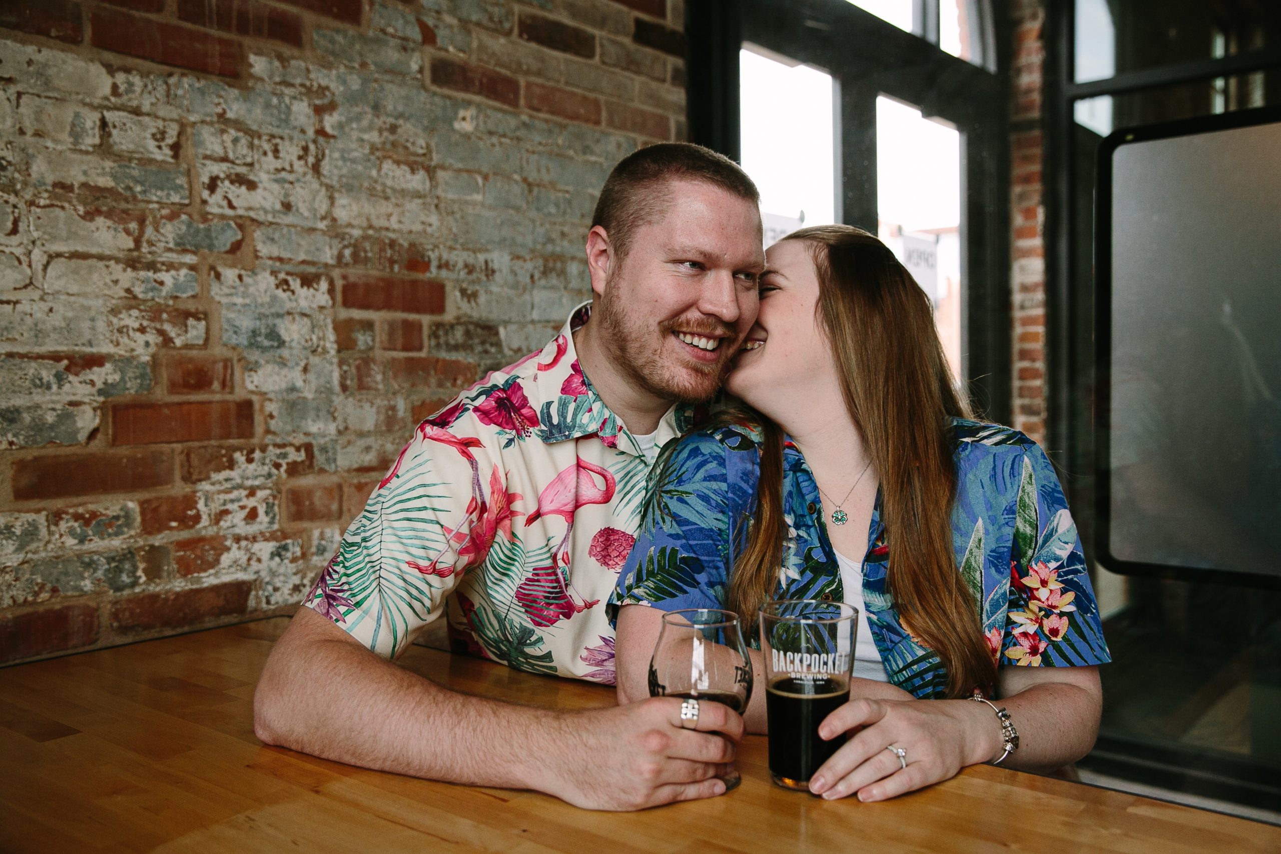 couple in hawaiian shirts talking at dubuque brewery