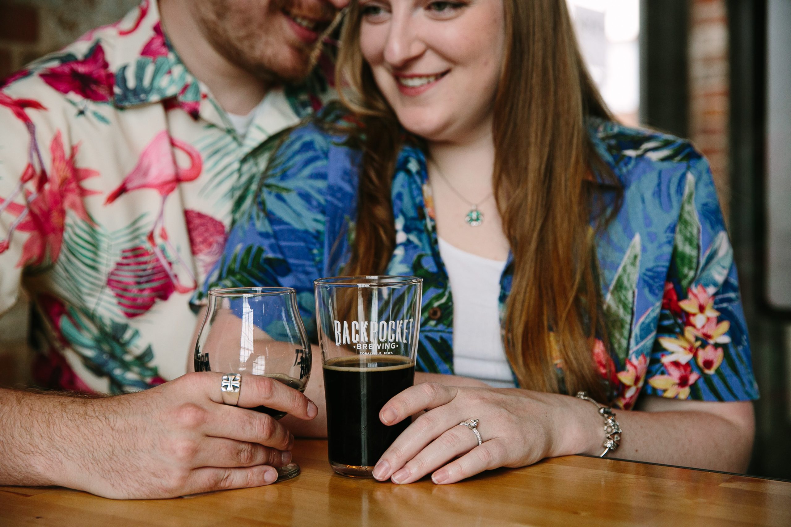 couple snuggling inside backpocket brewing during dubuque engagement session