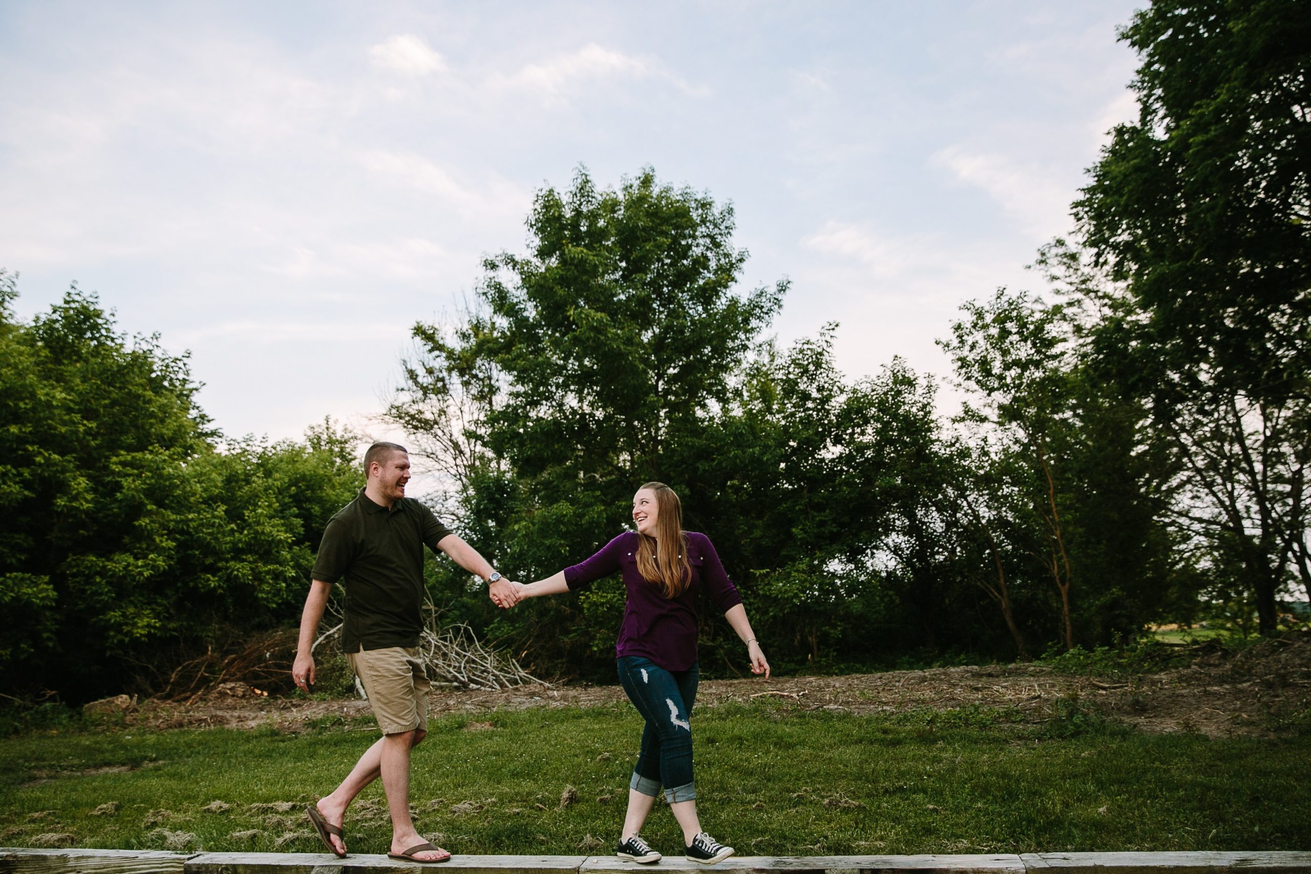 couple walking during engagement photos in dubuque iowa