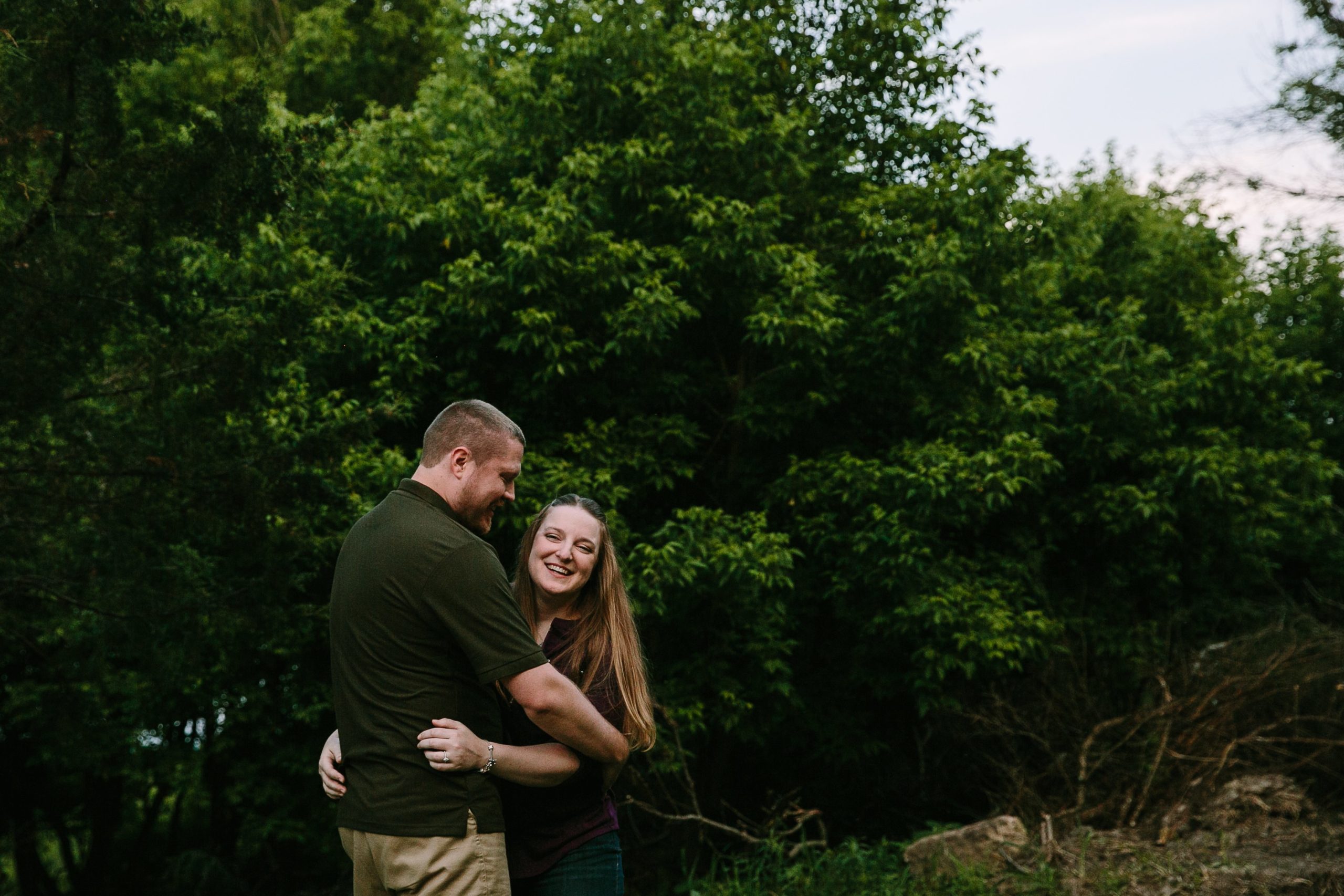 couple laughing during their dubuque engagement session at the mines of spain