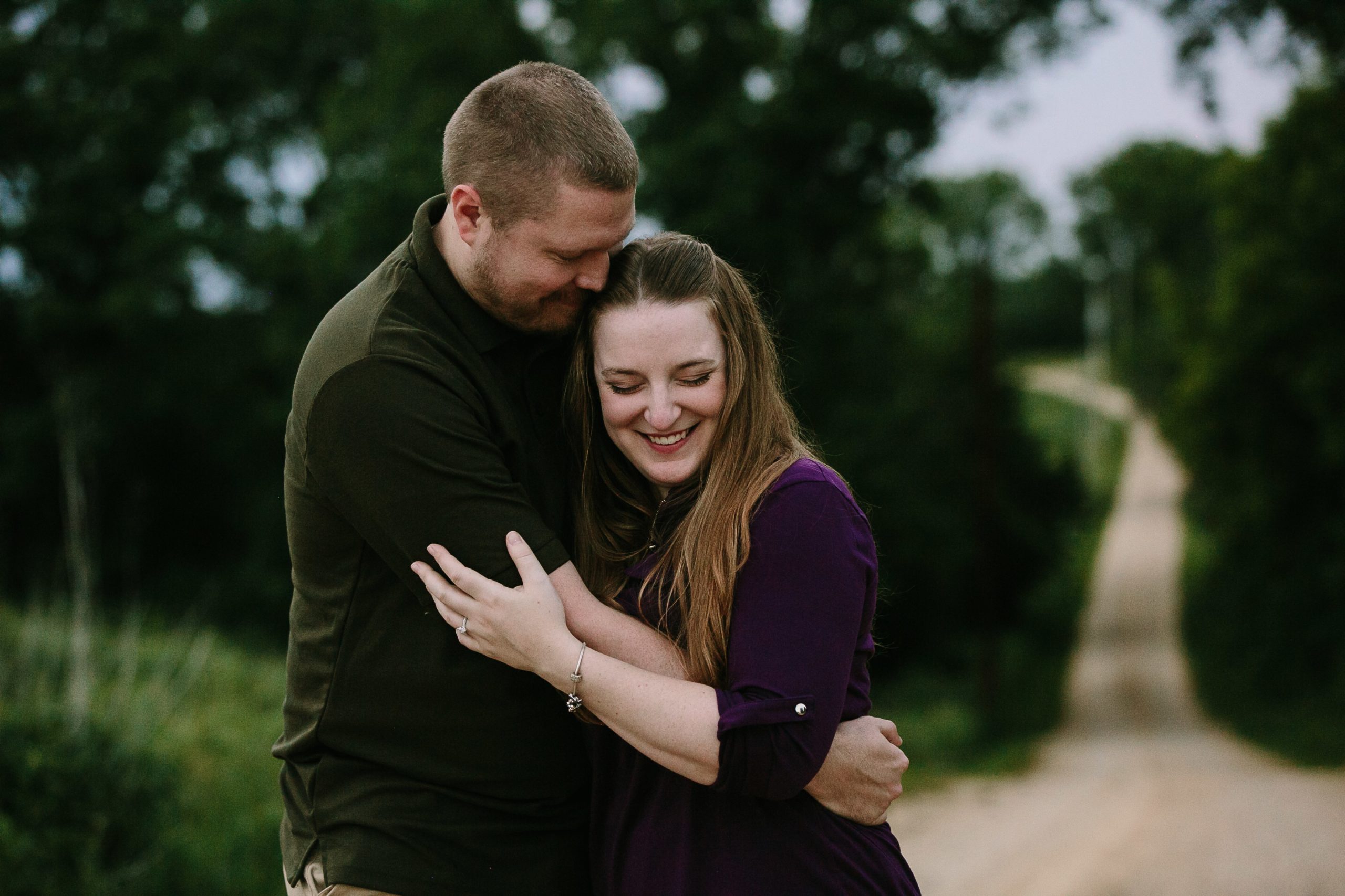 engaged couple embrace during photo session in dubuque