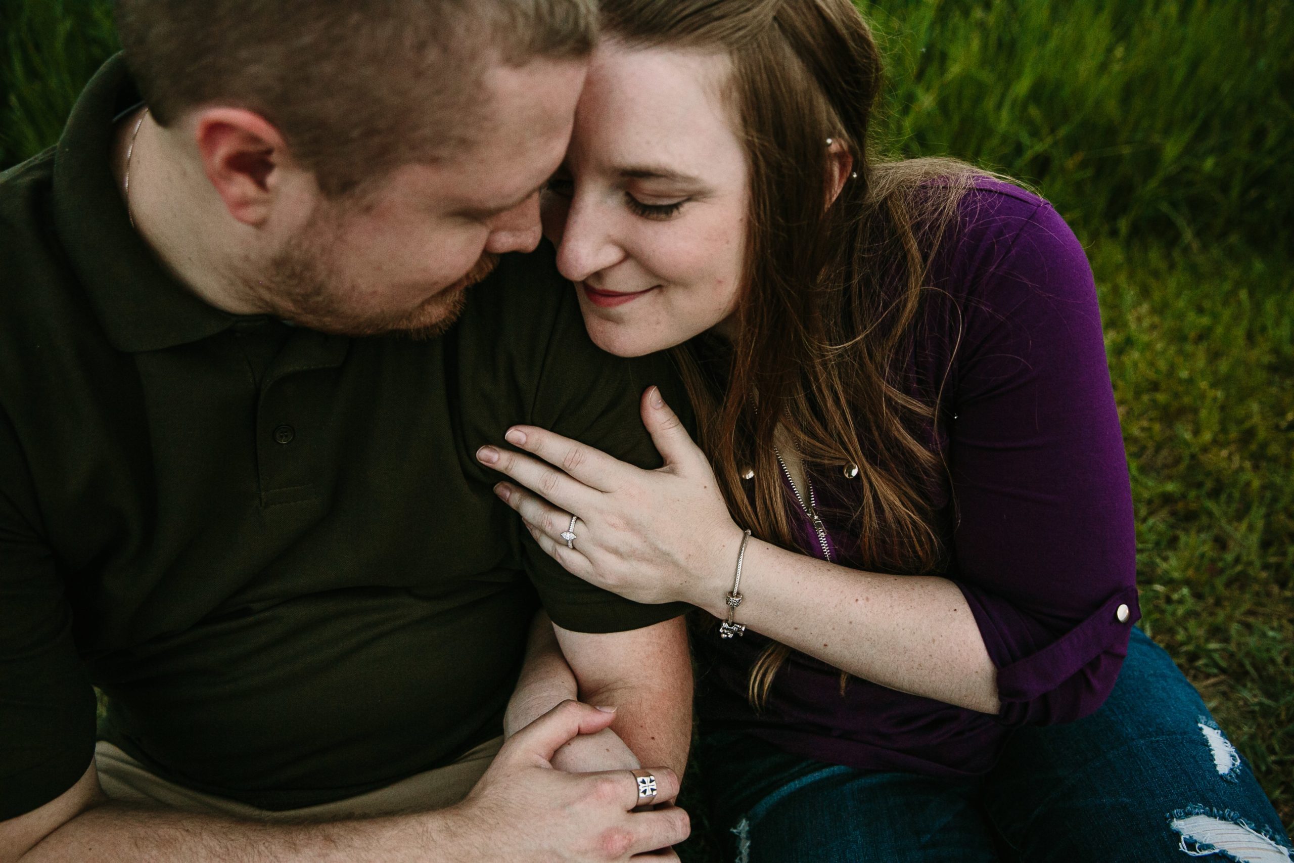 couple snuggling during engagement photos in dubuque iowa