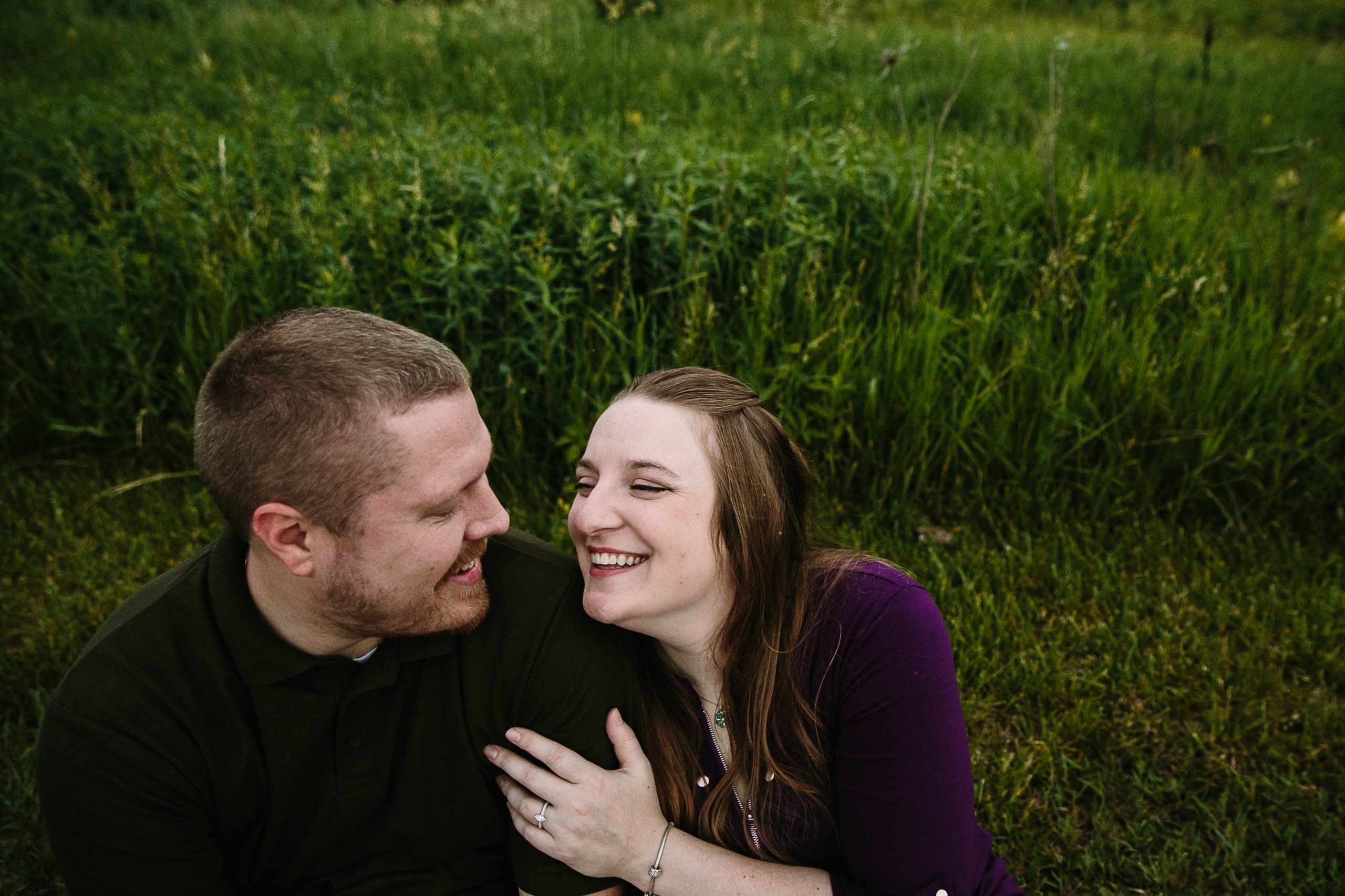 couple laughing during engagement photos in dubuque iowa