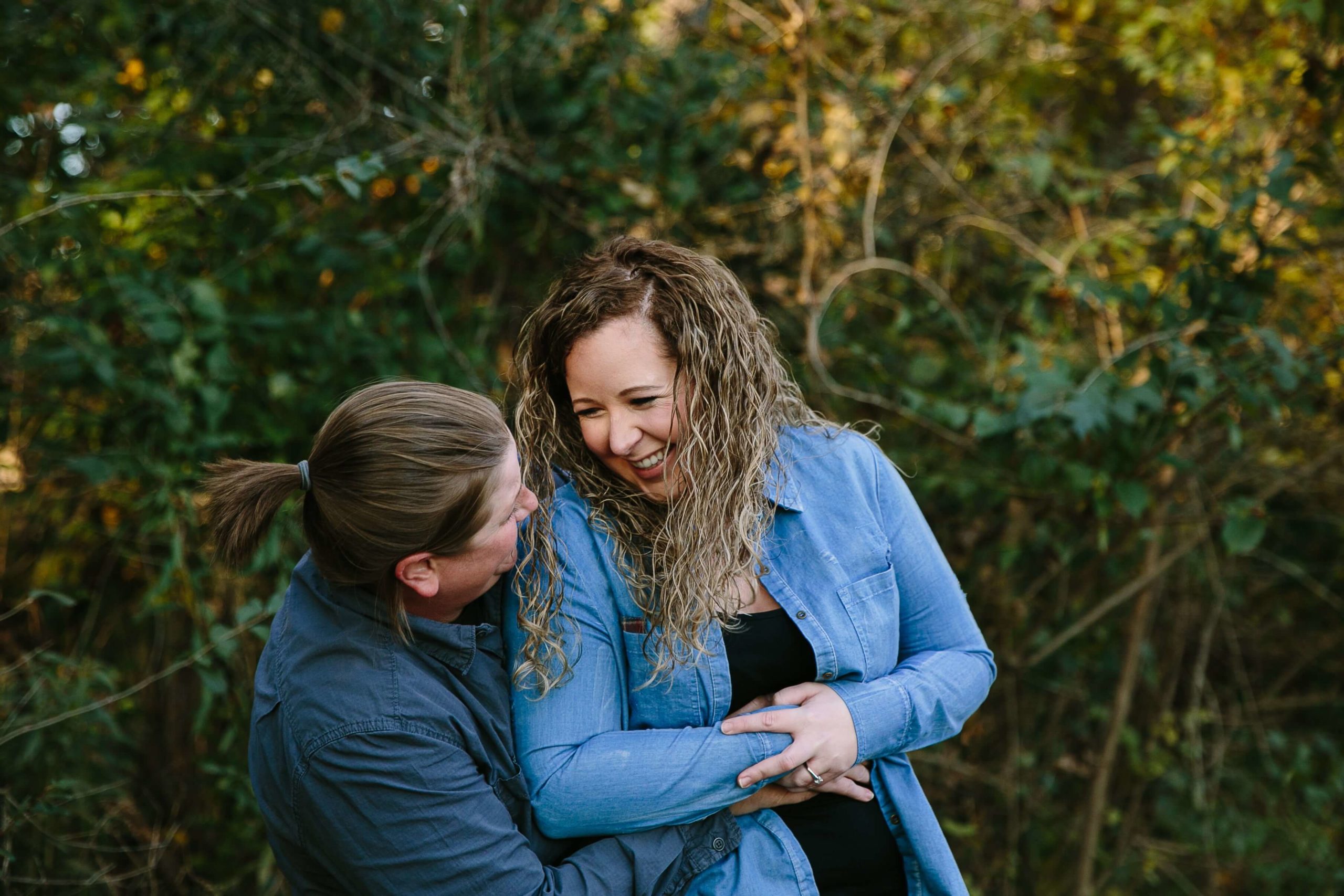 couple laughing during their dubuque engagement session at the bellevue state park