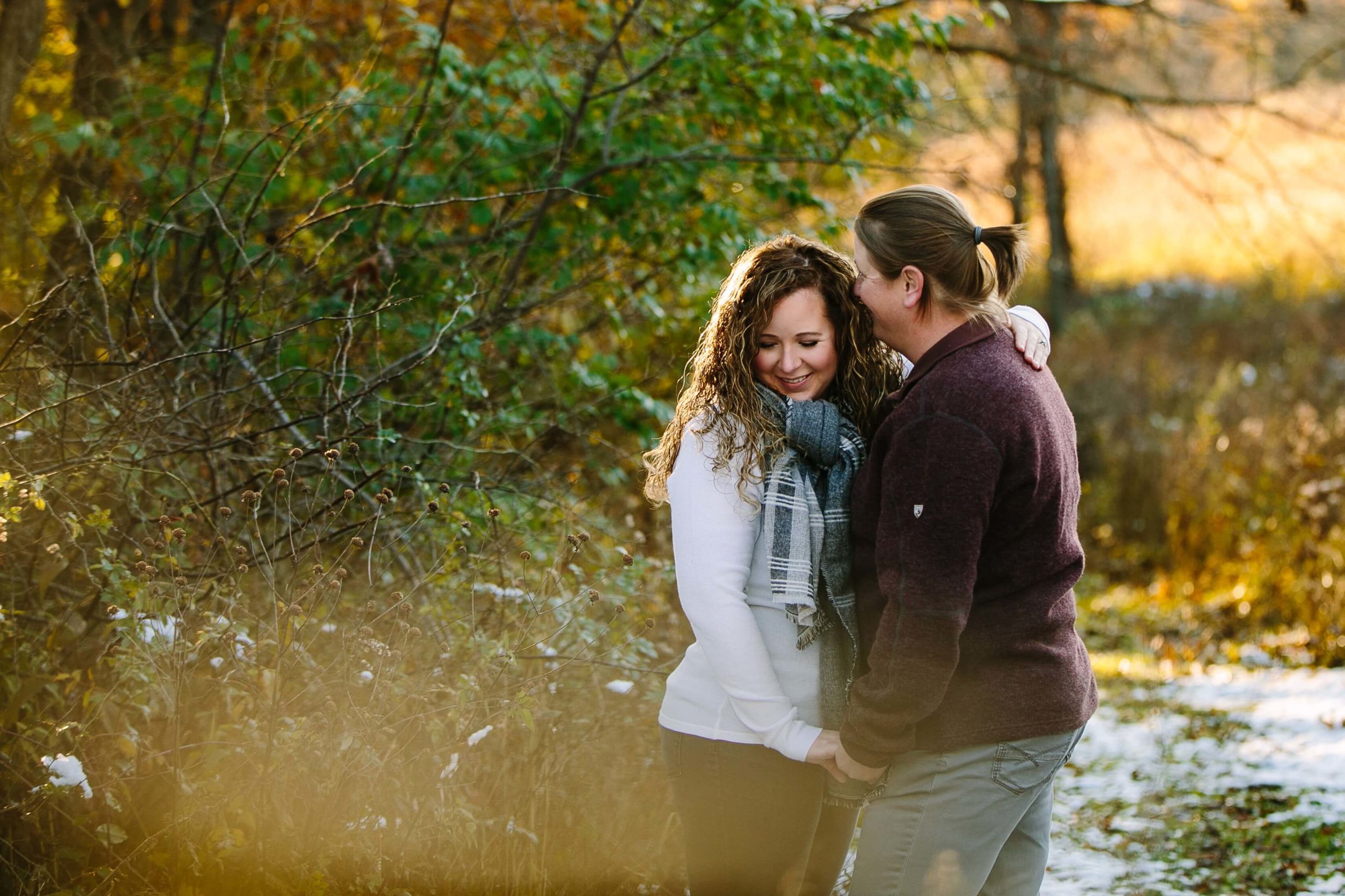 couple cuddles at sunset during iowa engagement session