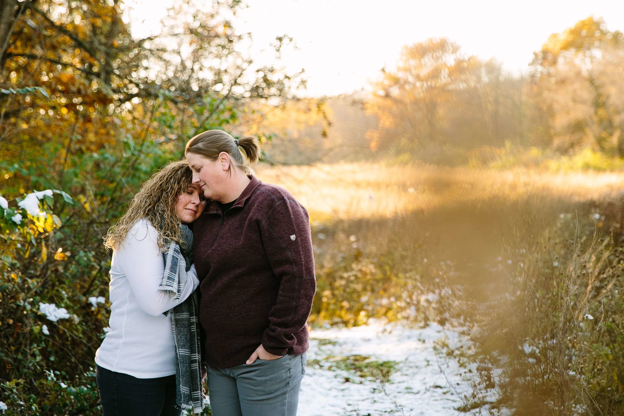 couple cuddles at sunset during their iowa engagement session