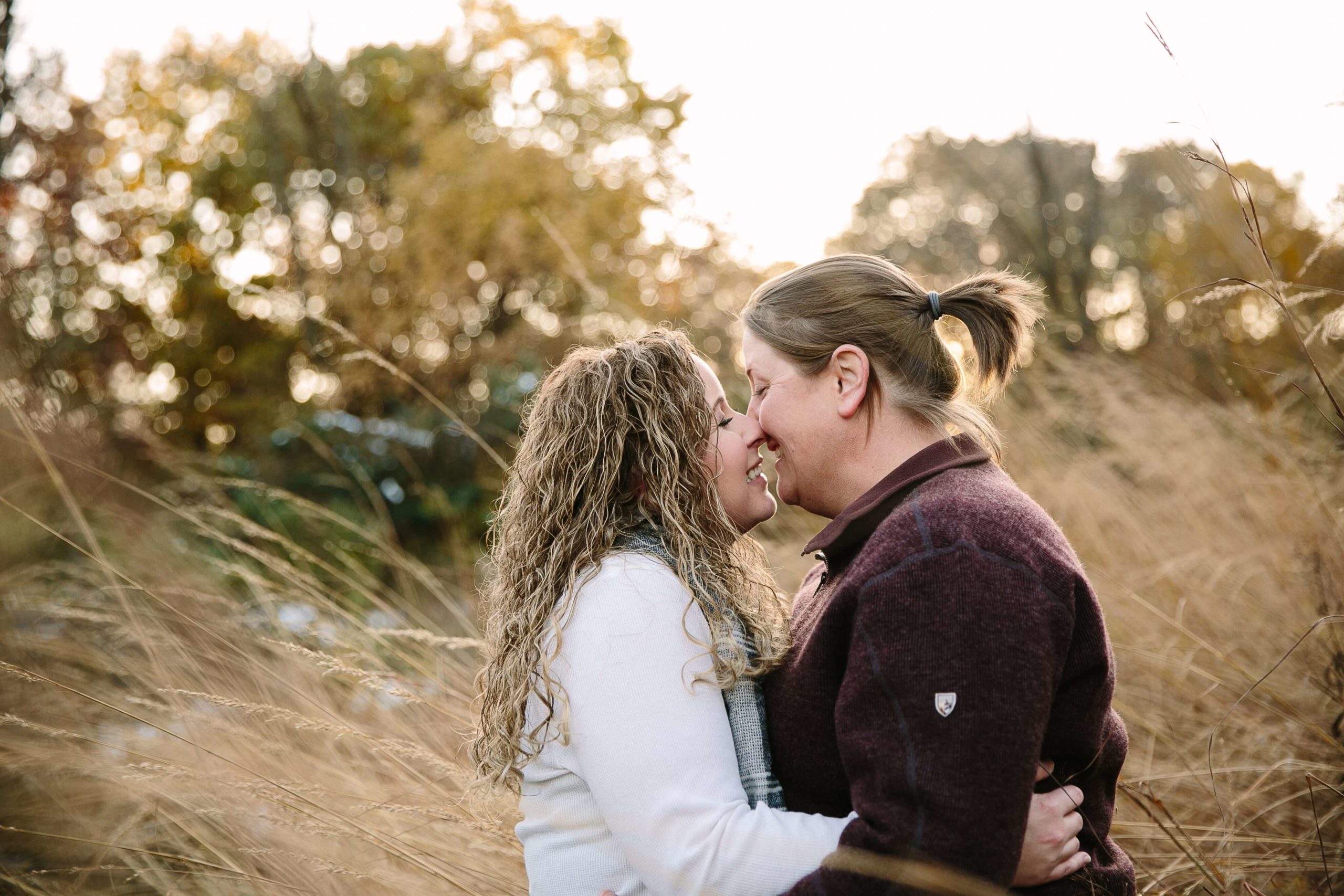 couple kissing during iowa engagement session at the bellevue state park