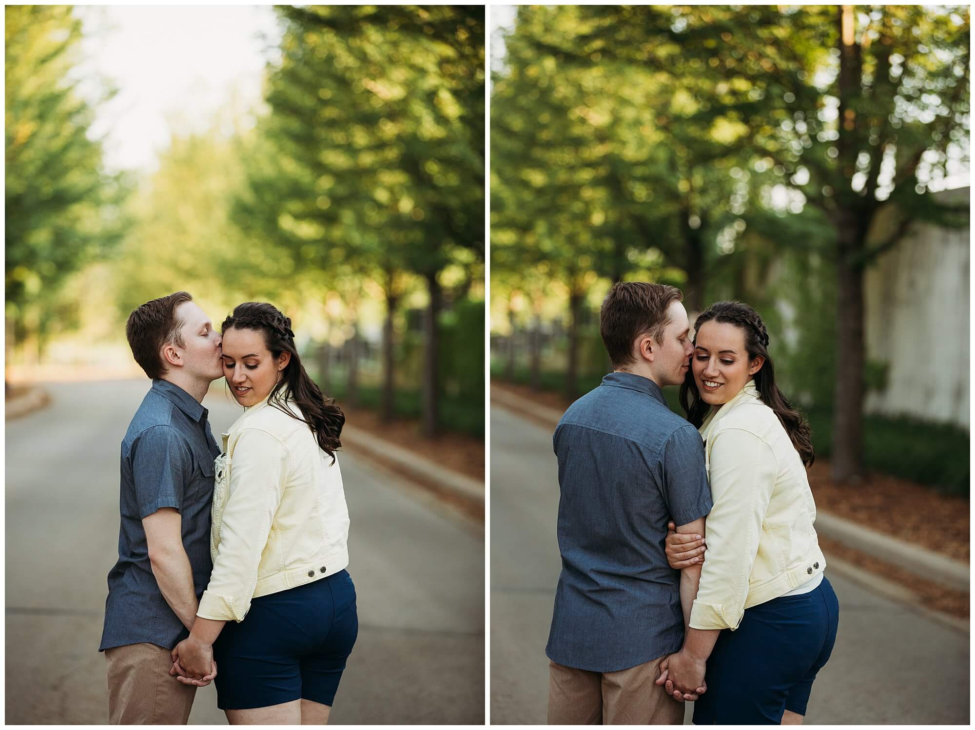 couple cuddling on a tree lined road during their dubuque engagement session