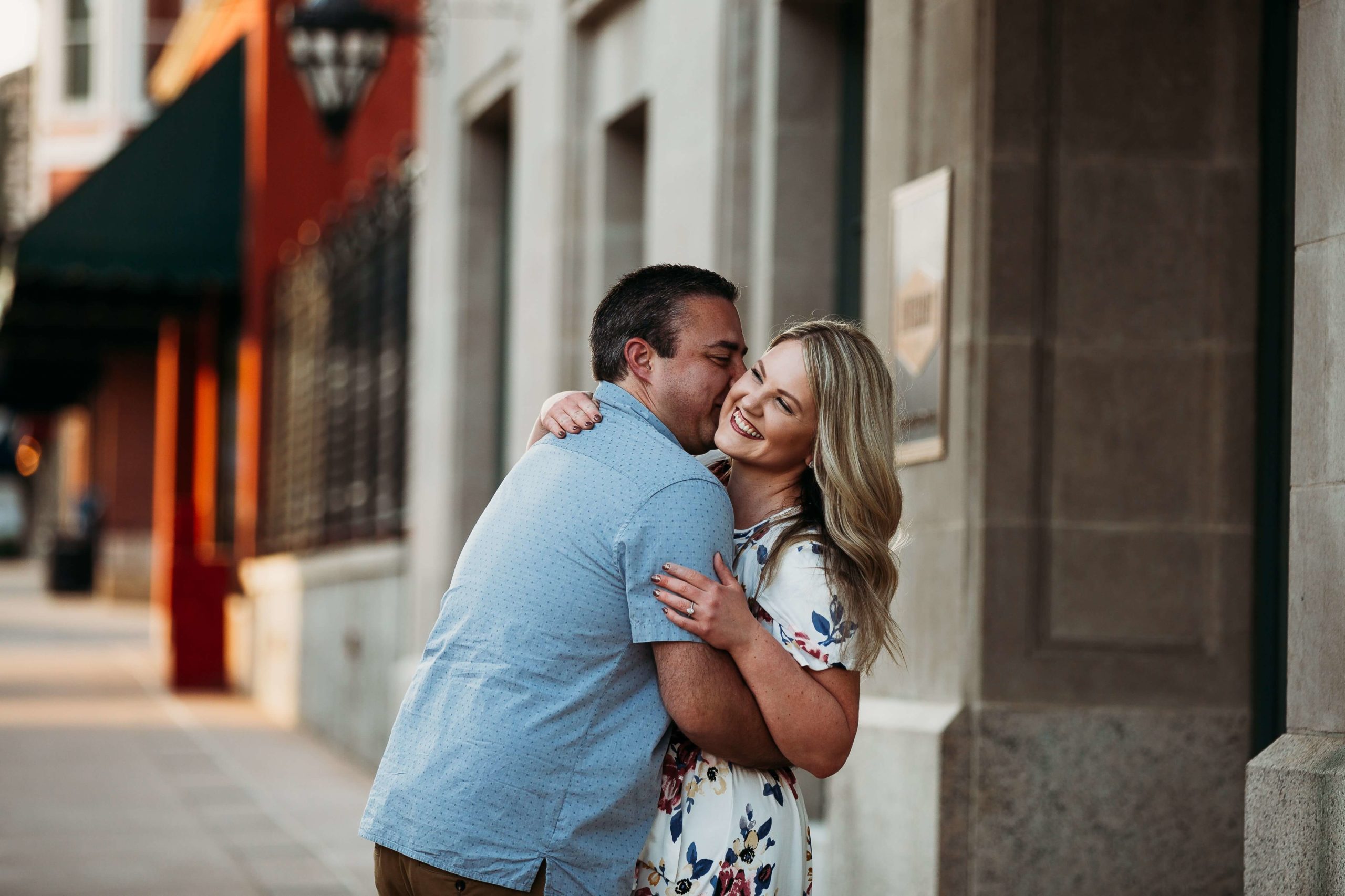 a couple laughing together during downtown dubuque engagement session