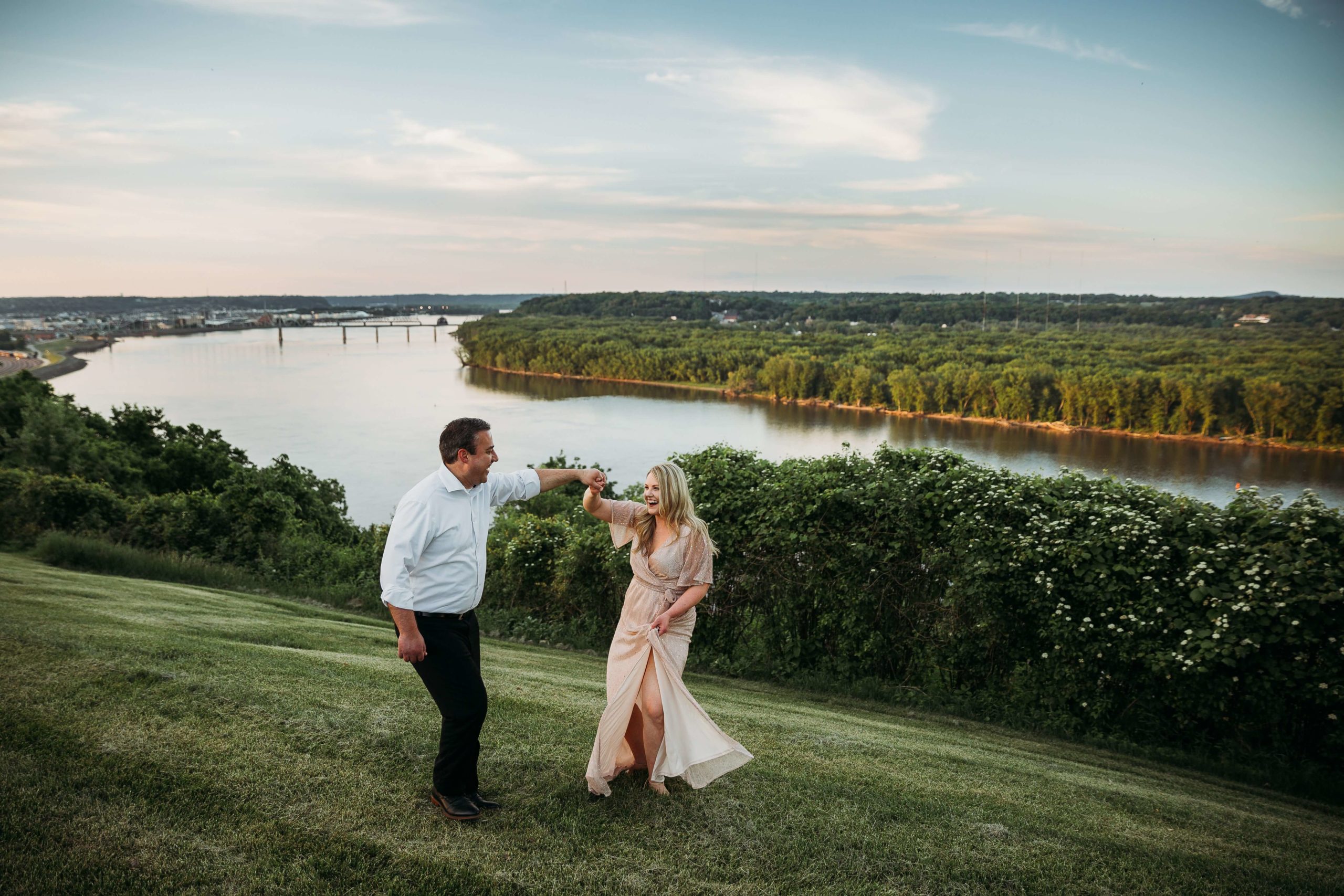 couple dancing together with a view of the mississippi river in the background