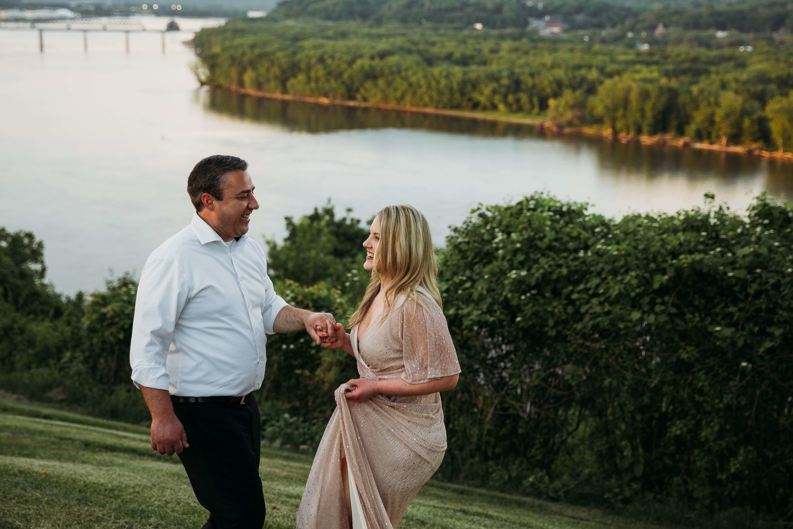 couple dancing together with a view of the mississippi river in the background