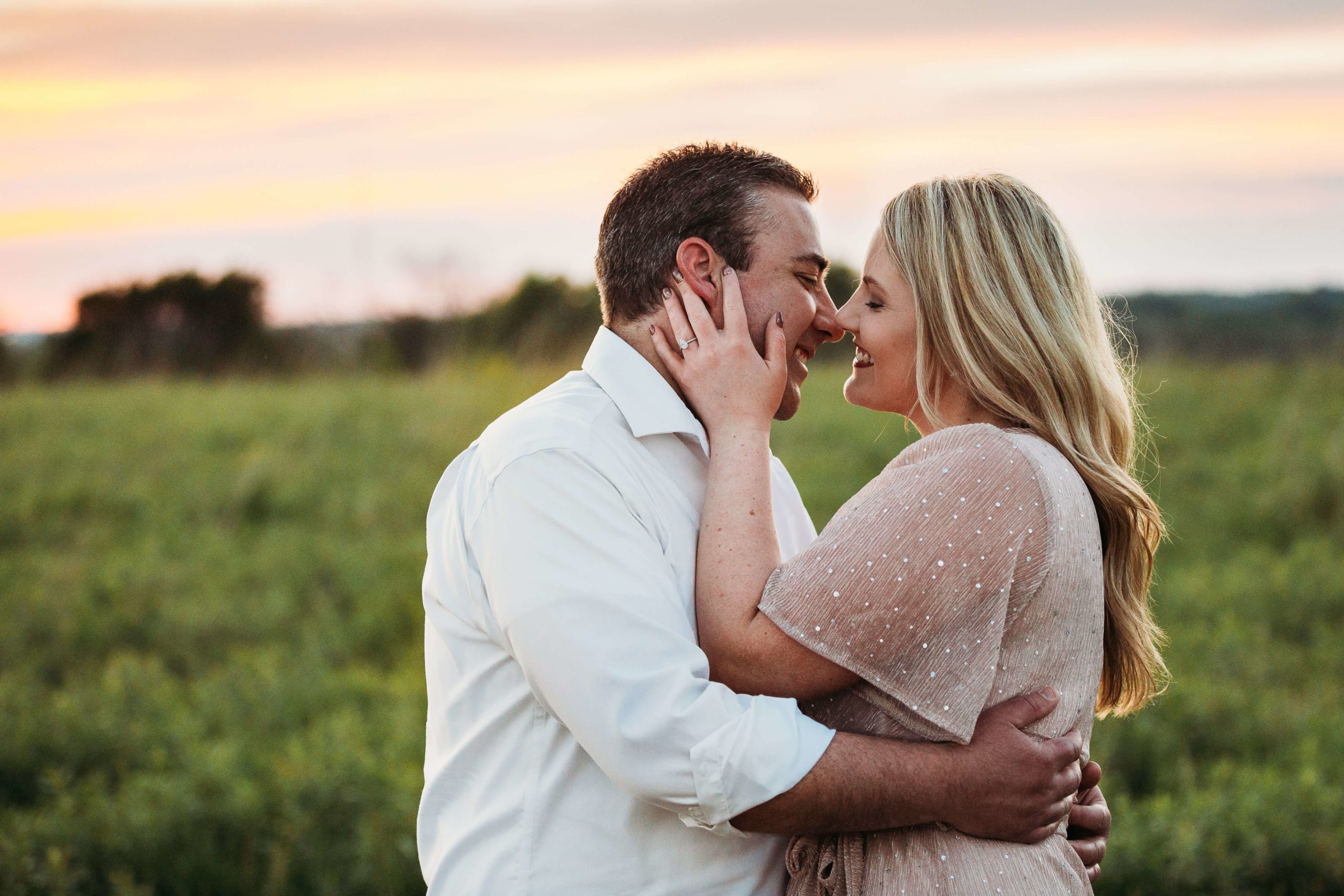 dubuque couple kissing at sunset during their engagement session